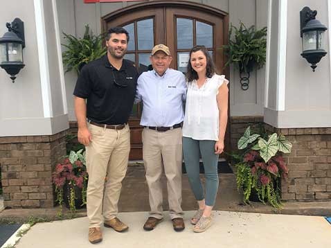 Company staff standing outside the front door of the business