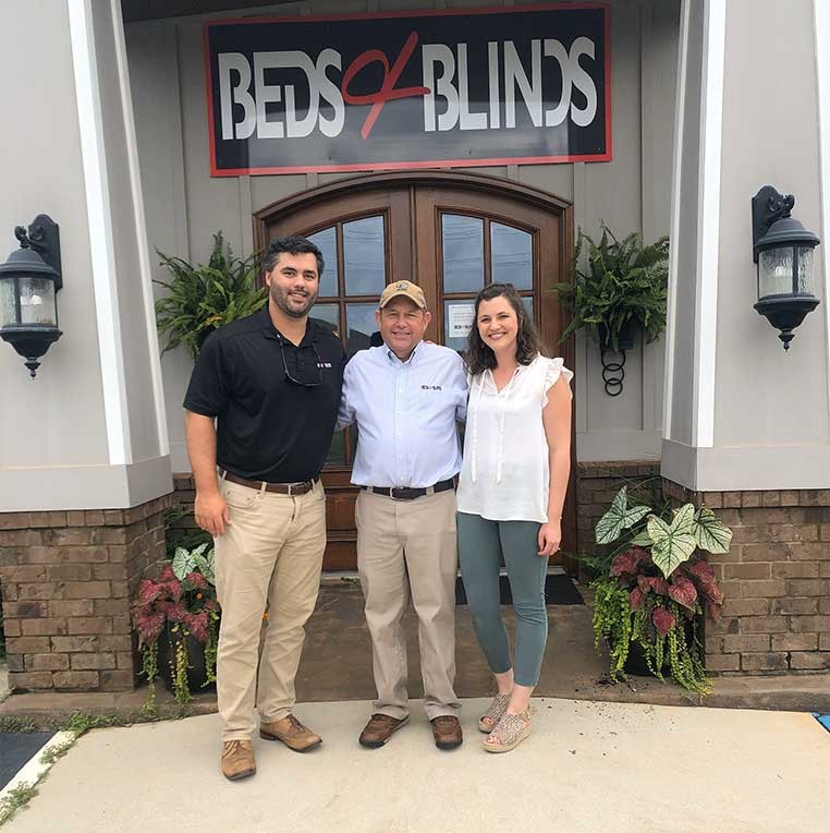 Company staff standing outside the front door of the business
